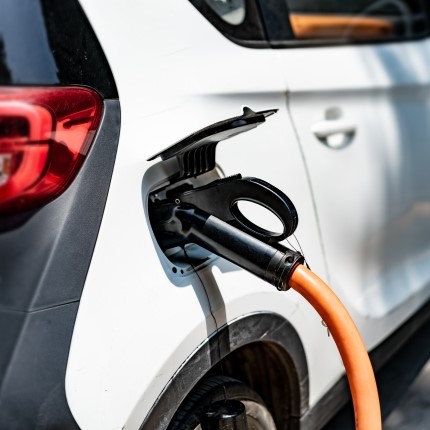car with EV charger plugged in