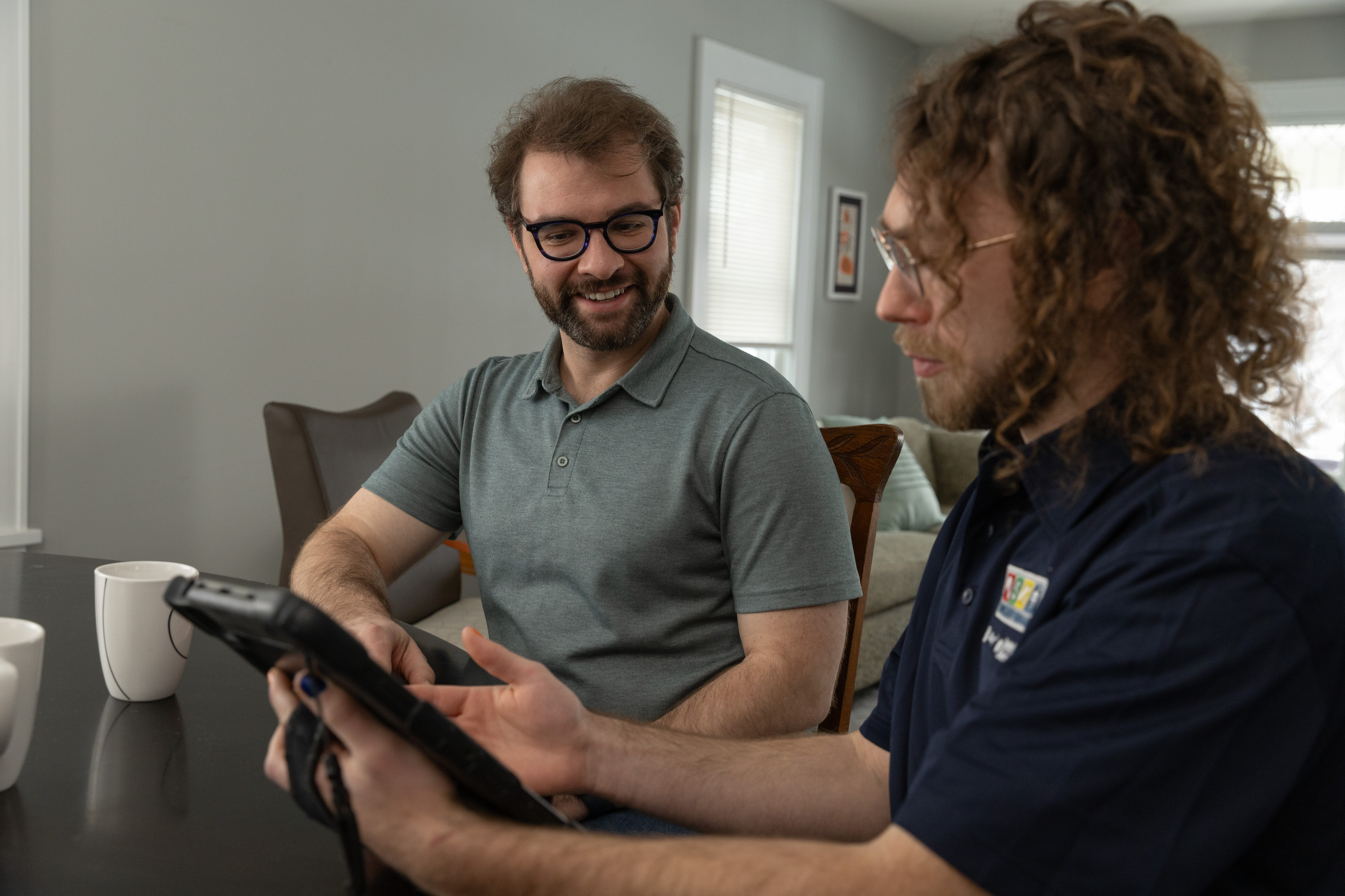 An HES auditor and a homeowner sit down together to review the home's audit findings.