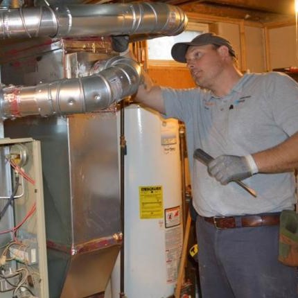 someone servicing residential HVAC equipment