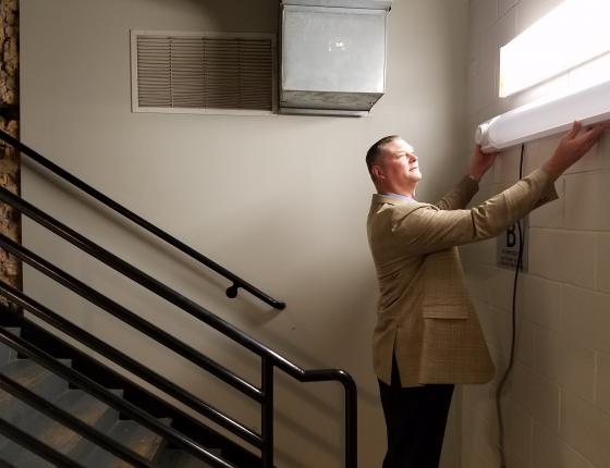 man installing light