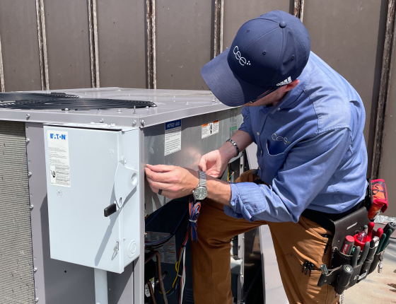 CEE staff checking rooftop unit of commercial HVAC system