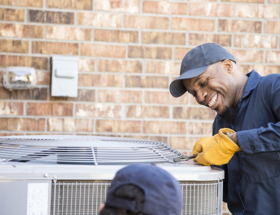 man repairing AC unit