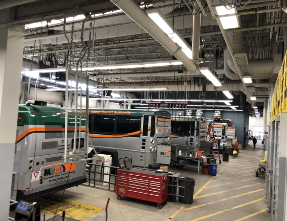 Garage with busses and overhead LED lighting