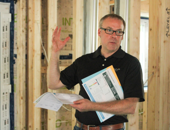 Phil Anderson speaking inside of a home