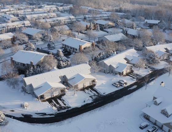aerial shot of homes in snow