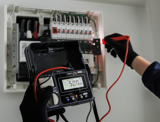 electrician testing electrical panel