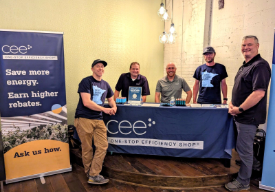 5 men at a CEE booth