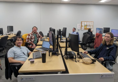 individuals sitting at desks with computers