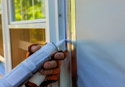 person adding insulation to side of house