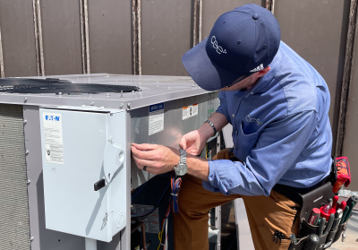 CEE staff checking rooftop unit of commercial HVAC system