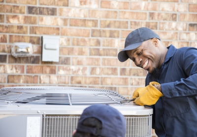 man repairing AC unit