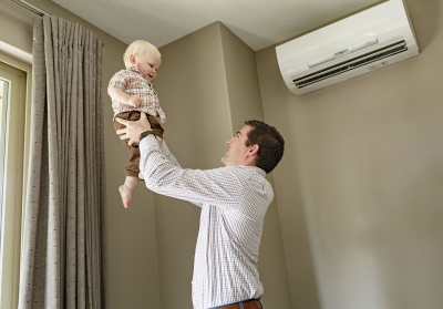 baby and a dad in front of an ASHP