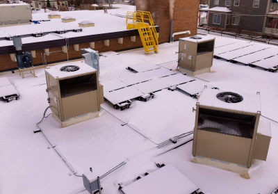 Rooftop units on a snowy rooftop