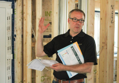 Phil Anderson speaking inside of a home