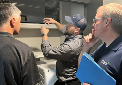 CEE staff explaining energy recovery ventilator in apartment unit