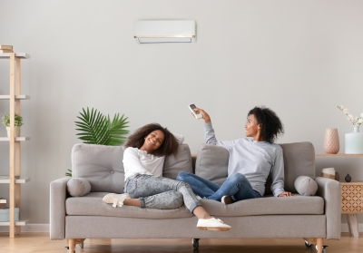 residents adjusting a wall-mounted heat pump unit