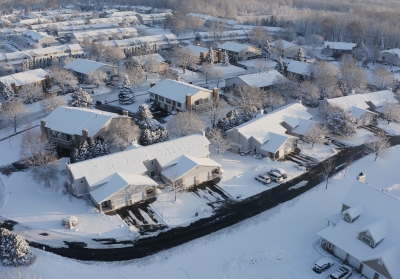 aerial shot of homes in snow