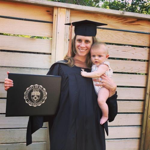 women holding baby and degree
