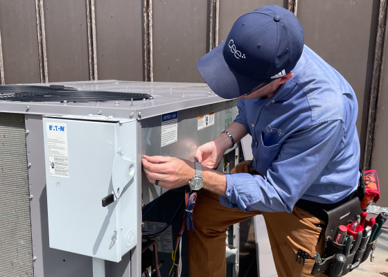 CEE staff checking rooftop unit of commercial HVAC system