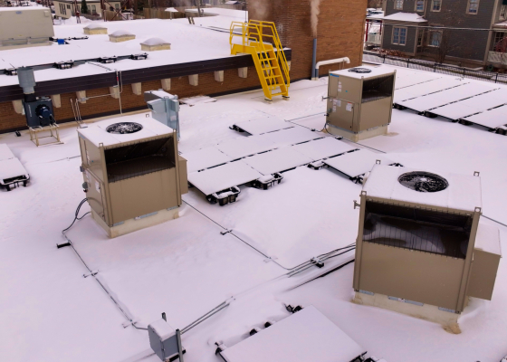 Rooftop units on a snowy rooftop