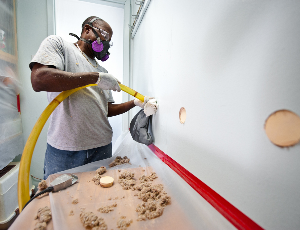 man installing insulation