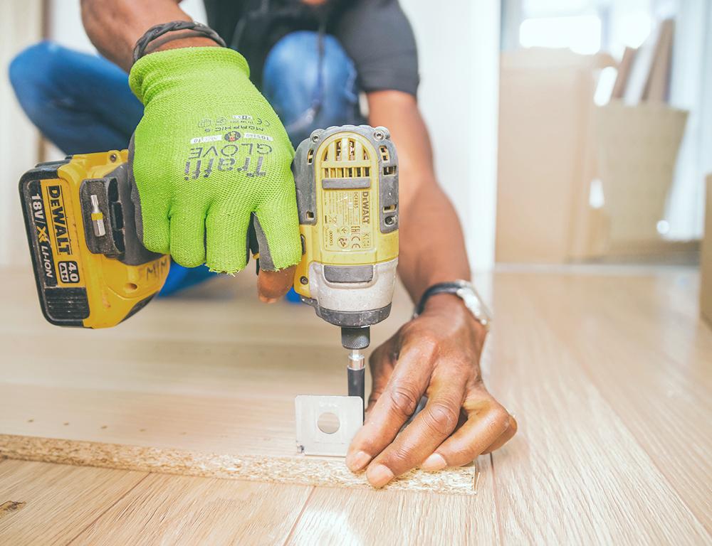 man drilling wood