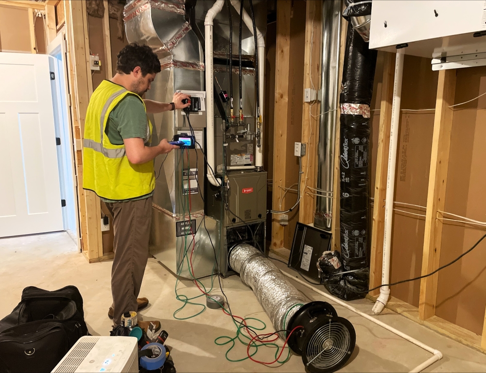 A person tests an HVAC system