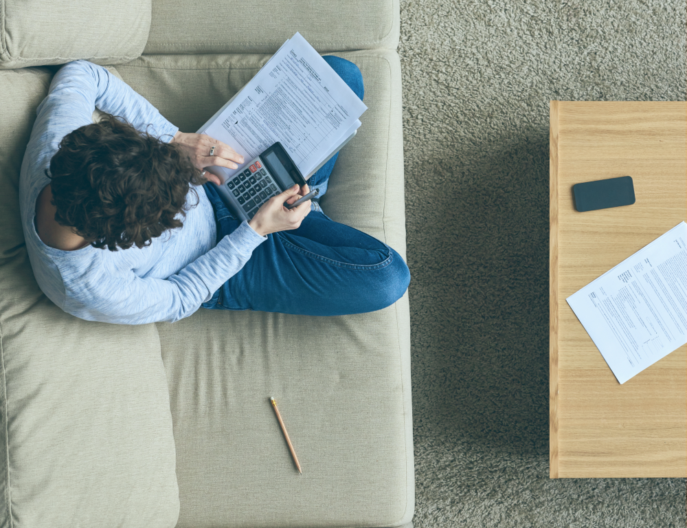 person doing paperwork on the couch