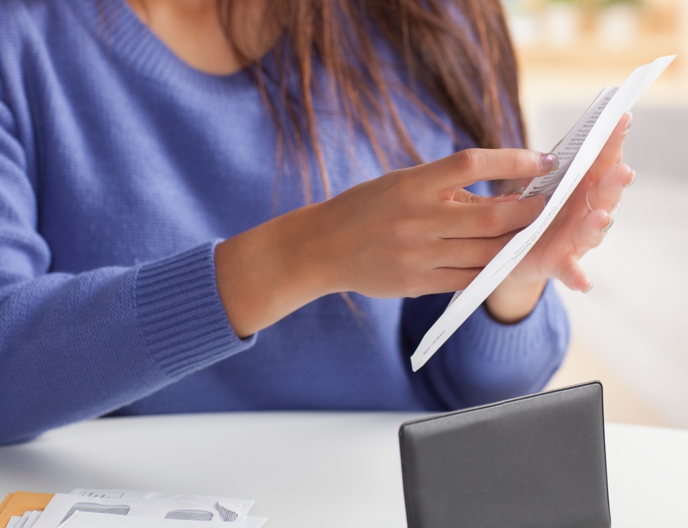 woman filling envelope