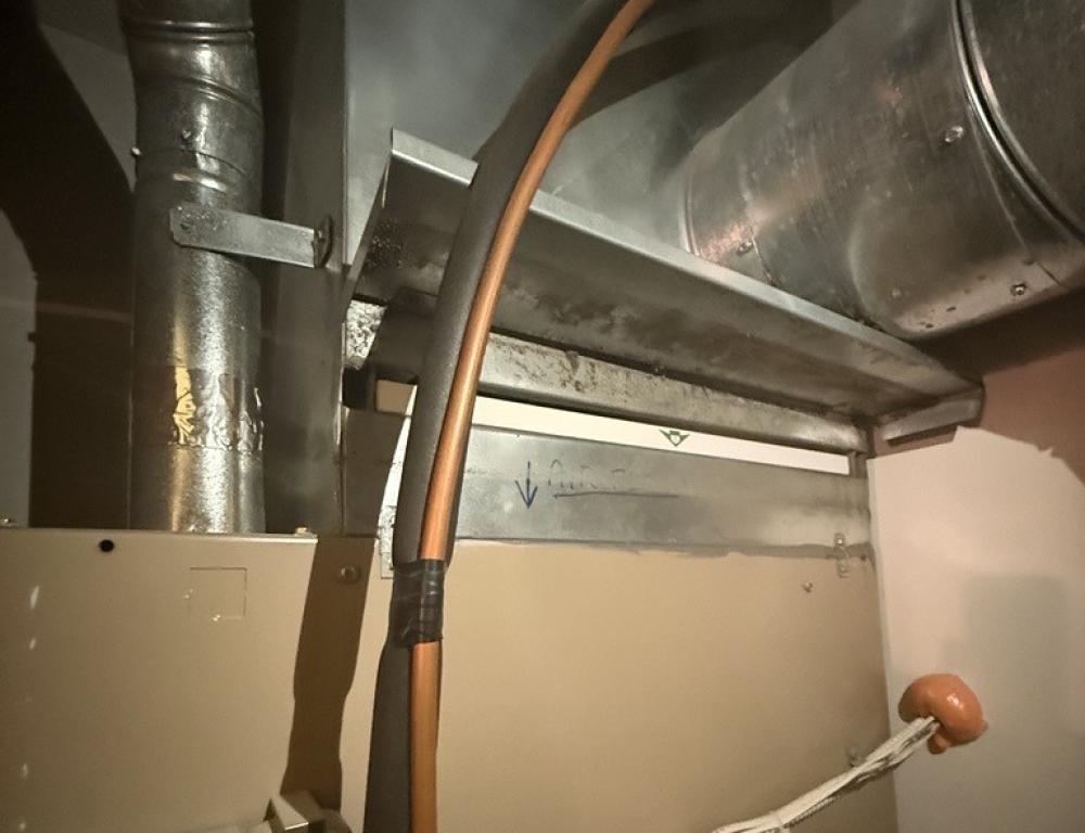 An image of a furnace with the filter properly installed. The arrows on the filter match the arrows that show air flow.