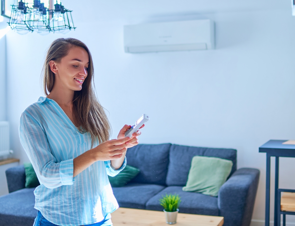 woman in front of air source heat pump 