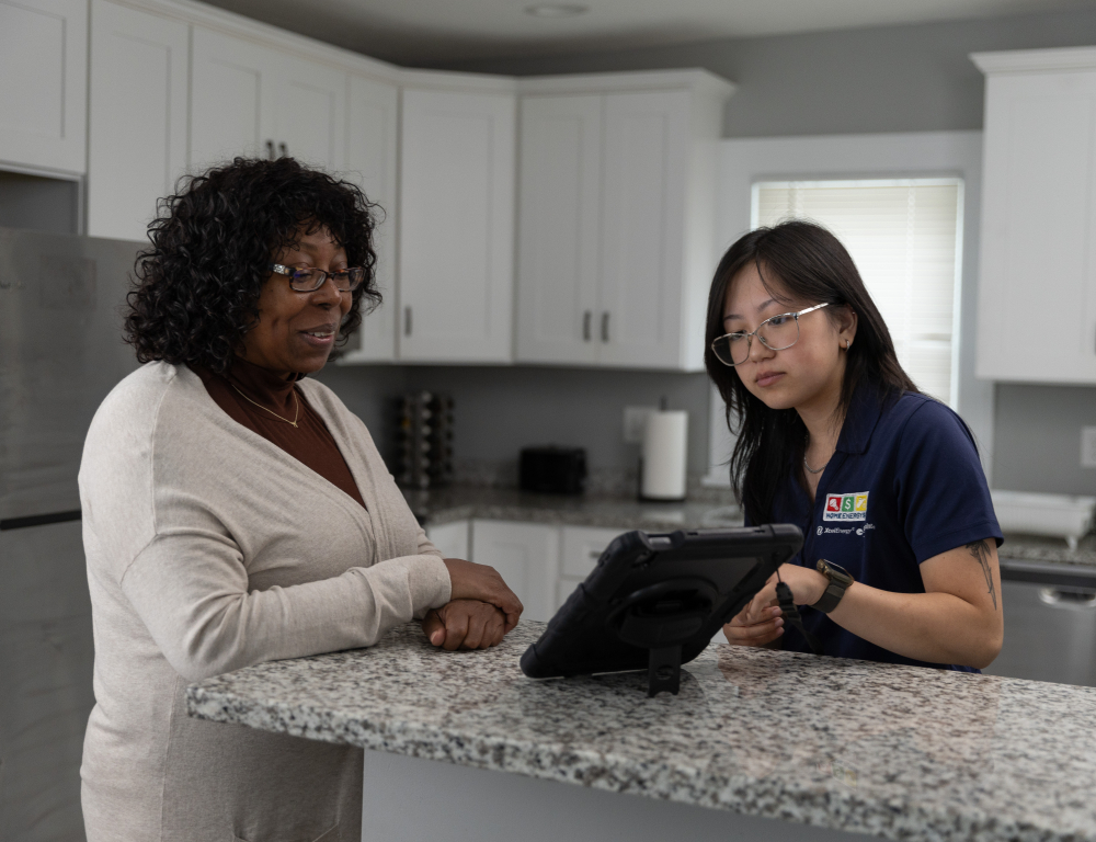 home energy squad employee visiting with homeowner 