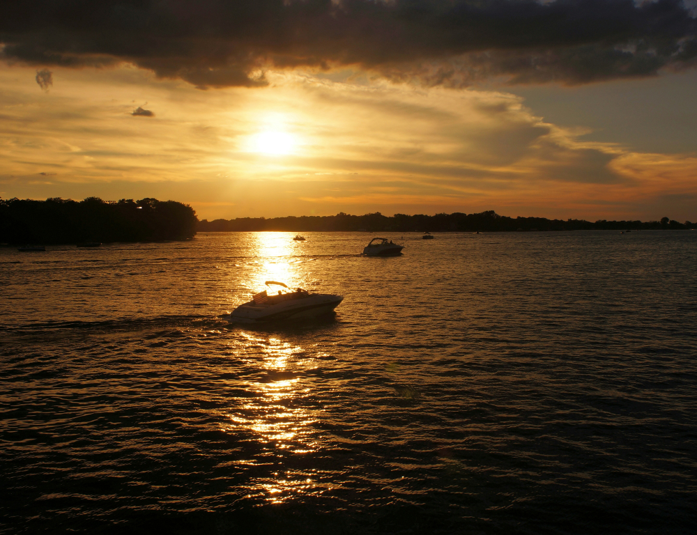 sunset over lake Minnetonka with boats on lake