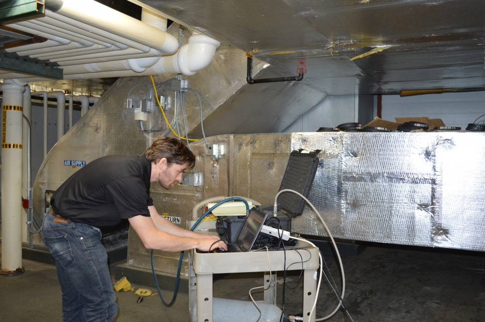 man monitoring data on a computer