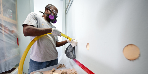 man installing wall insulation 