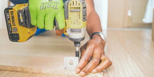 man drilling wood