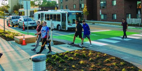 people walking in a cross walk