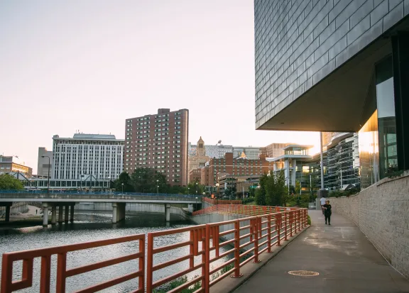 person walking near body of water in city