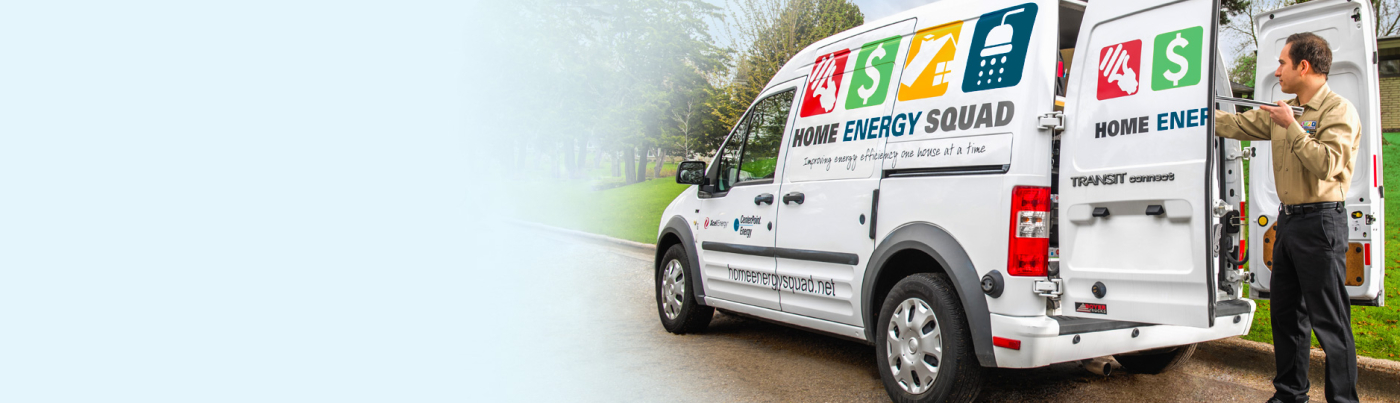 An auditor gets energy-saving materials out of a Home Energy Squad van.