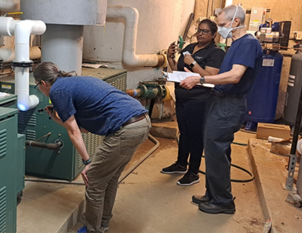 a group of engineers checking out machinery