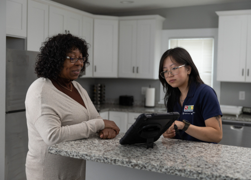 home energy squad employee visiting with homeowner 