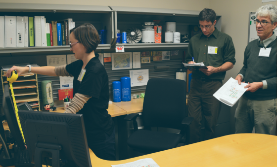 women measuring a desk space