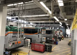 Garage with busses and overhead LED lighting