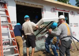 Dean and team install triple-pane window into affordable home